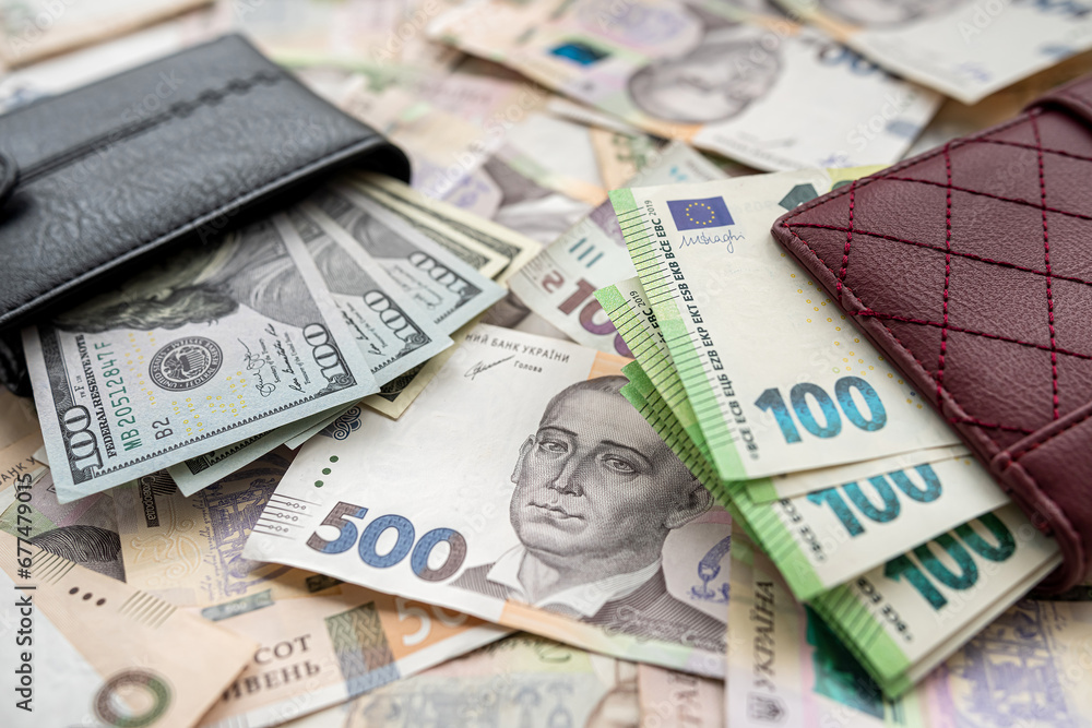 Money 100 dollars and 100 euros in wallet vs 500 1000 ukrainian hryvnia. exchange concept Money 100 dollars and 100 euros in wallet vs 500 1000 ukrainian hryvnia. exchange concept