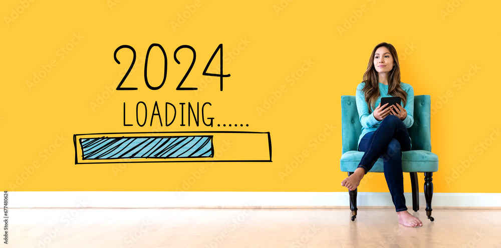 Loading new year 2024 with young woman holding a tablet computer - obrazy, fototapety, plakaty 