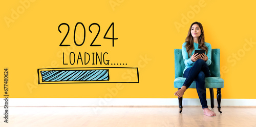 Loading new year 2024 with young woman holding a tablet computer photo