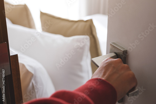 Closeup image of a hand opening bedroom door photo