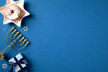 Hanukkah table adorned with menorah, sufganiyot, gift box. Celebrate the holiday spirit with this cultural greeting card design