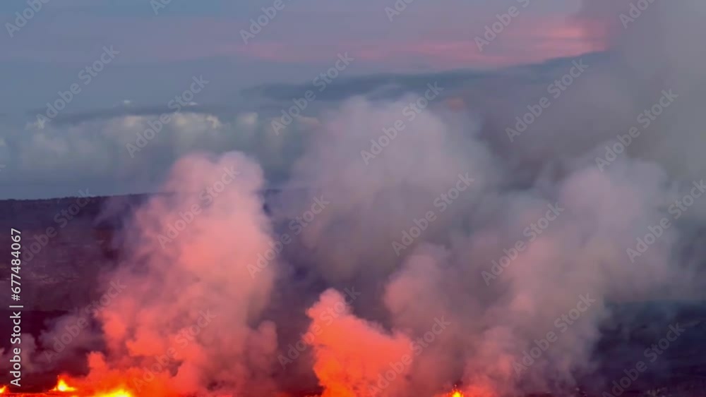 Cinematic long lens booming down shot of the glowing lava lake at Kilauea as the volcano erupts at sunset on the first day of activity in September 2023 on the island of Hawai'i. 4K HDR at 30 FPS Cinematic long lens booming down shot of the glowing lava lake at Kilauea as the volcano erupts at sunset on the first day of activity in September 2023 on the island of Hawai'i. 4K HDR at 30 FPS