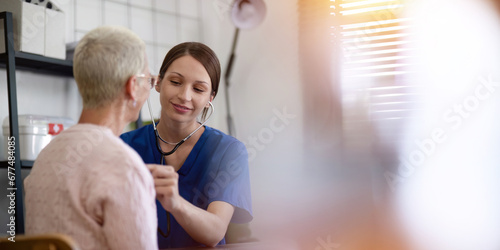 Physical therapist caregiver give advice about medicine to a senior women patient in rehabilitation. Physiotherapy healthcare, Medical caregiver consulting disabled elderly patient at home