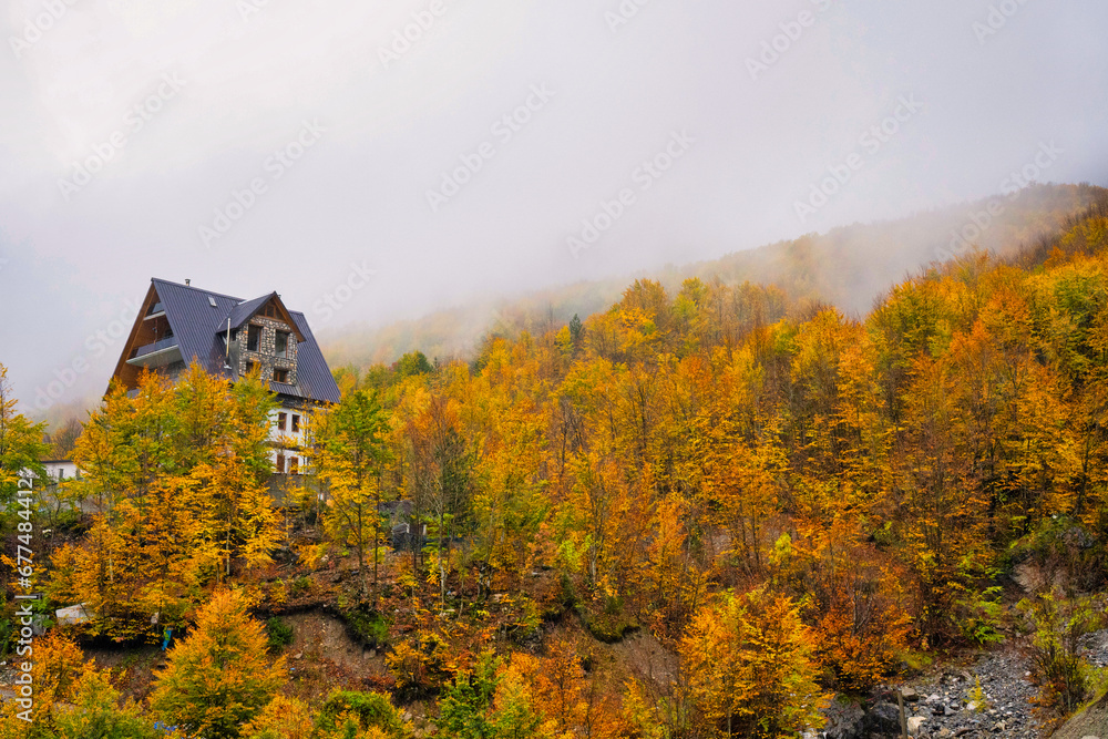 Autumnal view of Thethi National Park in Northern Albania showing clouds and the spectacular colors of Autumn. 