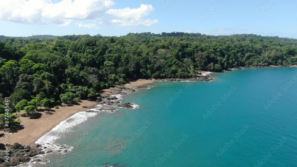 Costa Rica beach drone top view showing sea, shore and palm tree forest in Corcovado National Park on a sunny day in the pacific ocean Costa Rica beach drone top view showing sea, shore and palm tree forest in Corcovado National Park on a sunny day in the pacific ocean