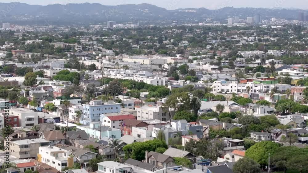 A rising aerial view of a residential neighborhood in Venice, California, apartment buildings and homes on tree lined streets A rising aerial view of a residential neighborhood in Venice, California, apartment buildings and homes on tree lined streets