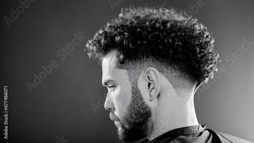 Profile of a man with curly hair in black and white
