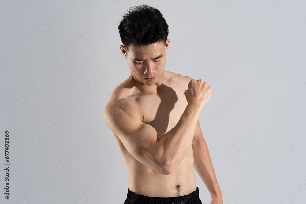 Fototapeta premium Image of Asian male athlete with good physique on white background