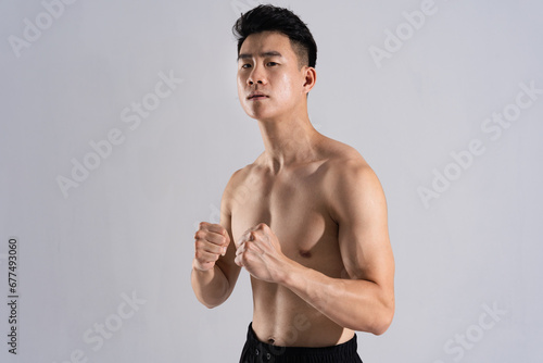 Image of Asian male athlete with good physique on white background