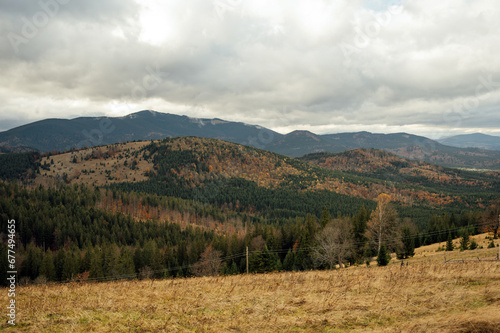 Golden autumn in the Carpathians. Mining arrays combined with trees with yellow leaves. Beautiful clouds and sun