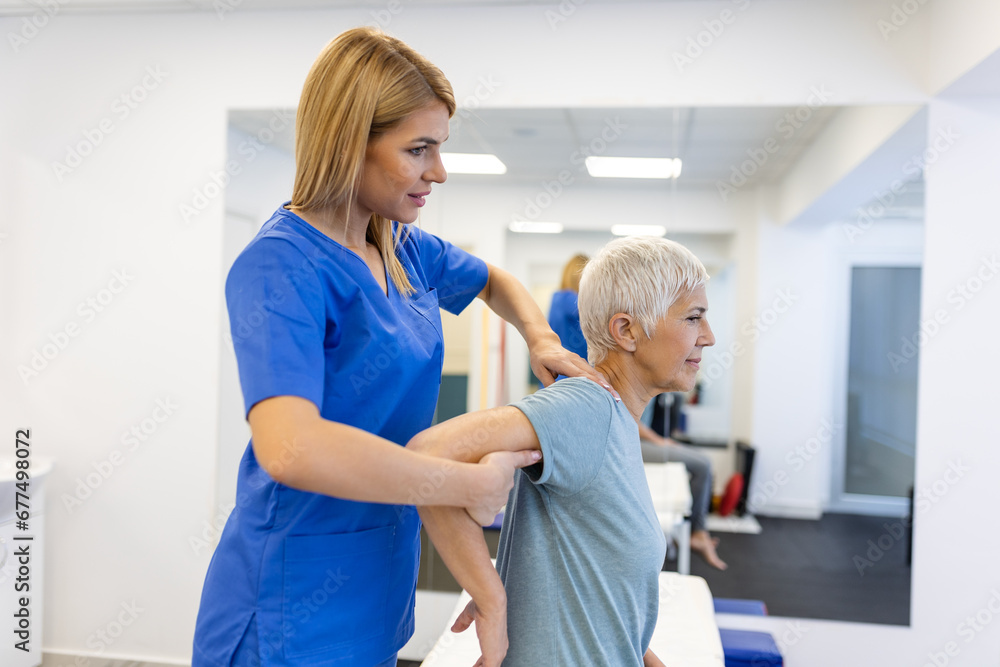 Doctor or Physiotherapist working examining treating injured arm of senior patient, stretching and exercise, Doing the Rehabilitation therapy pain in clinic. Doctor or Physiotherapist working examining treating injured arm of senior patient, stretching and exercise, Doing the Rehabilitation therapy pain in clinic.