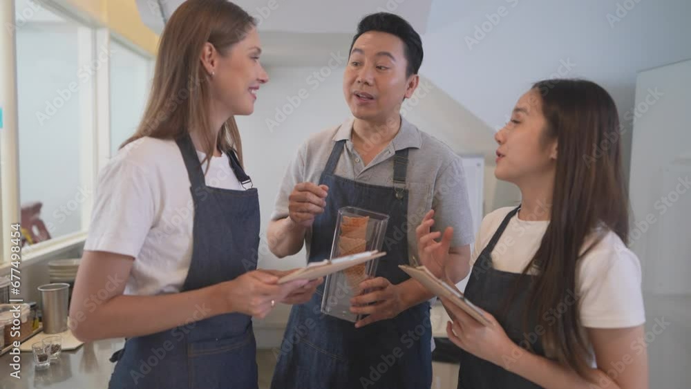 Barista workers are prepared at the counter pantry of coffee. Man and women enjoy their work. Worker meeting and talk before the cafe open. Barista workers are prepared at the counter pantry of coffee. Man and women enjoy their work. Worker meeting and talk before the cafe open.