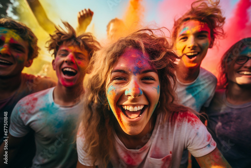 Shot of a group of teenagers having fun with colourful powder at summer camp photo