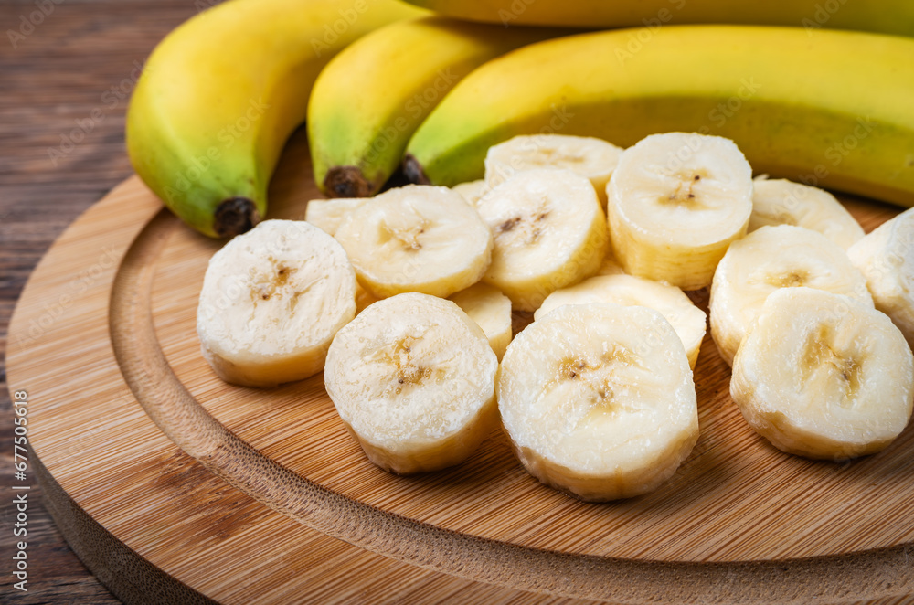 Slices of banana on a wooden board. Selective focus.