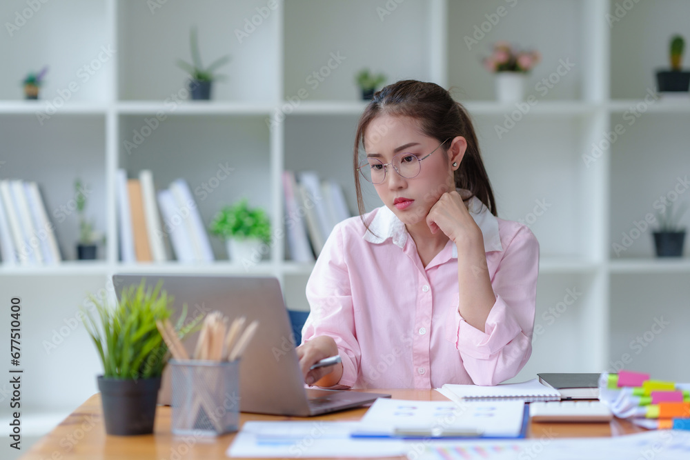 Young Asian businesswoman stressed by overwork at office. Beautiful Asian businesswoman stressed with work glitches in the office. Young Asian businesswoman stressed by overwork at office. Beautiful Asian businesswoman stressed with work glitches in the office.