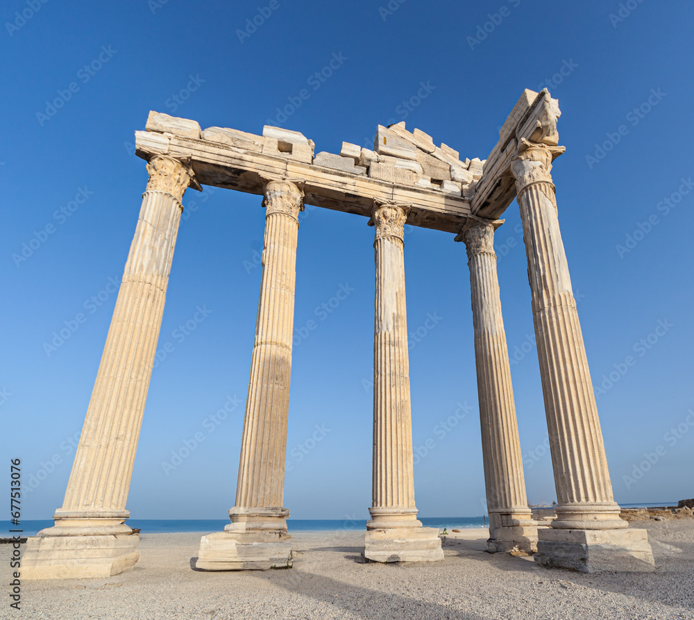 Explore ancient ruins of a temple in a clear blue sky.