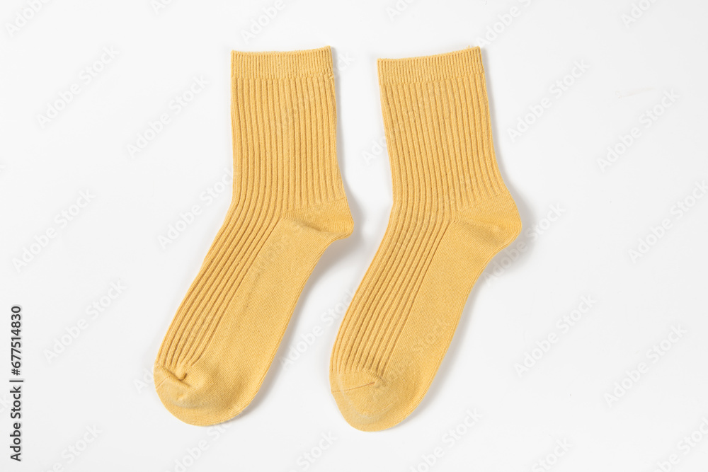 a pair of yellow socks laid out on white background a pair of yellow socks laid out on white background