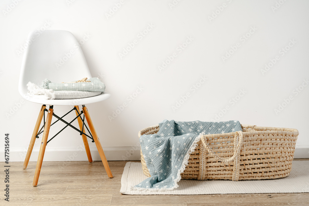 Baby cradle with muslin blanket and wooden toys in a baby room - obrazy, fototapety, plakaty 