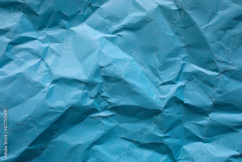 Crumpled blue paper as background.