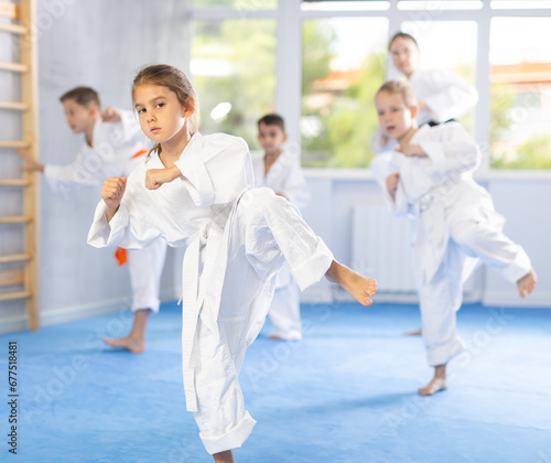 Kids are dedicated to their martial arts training, diligently working on their stances and techniques every day.