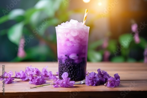 Purple berries milk shake with tapioca sweet balls, asian trendy drink bubble tea on wooden table in cafe.