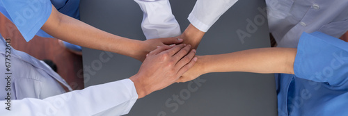 Group of medical staff doctor nurse and healthcare specialist profession forming synergy hand in hospital. Medical teamwork and healthcare cooperation in top view panoramic banner background. Neoteric
