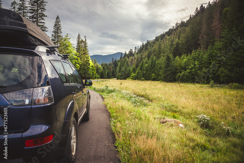 Woman in white bathrobe lying on sofa and relaxing with orange cocktail at the roof.