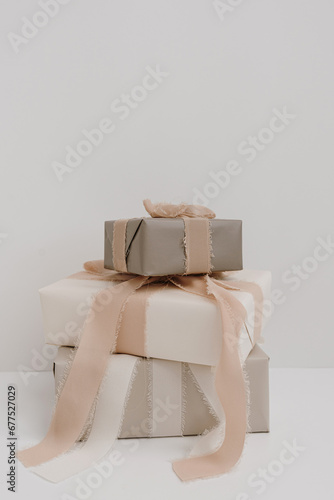 Christmas, New Year composition. Stack of handmade winter holidays gift boxes with bows and ribbons. Festive packaging concept