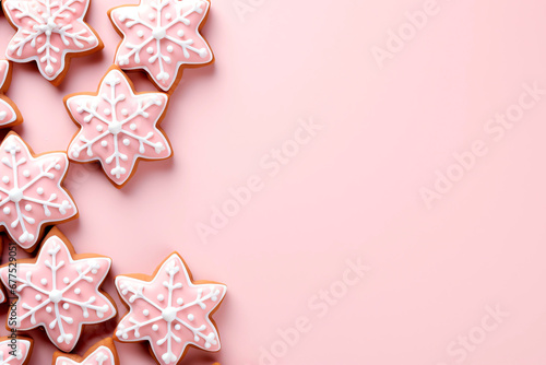 Ginger snowflakes decorated with icing, on pink background, flat lay. Place for text.