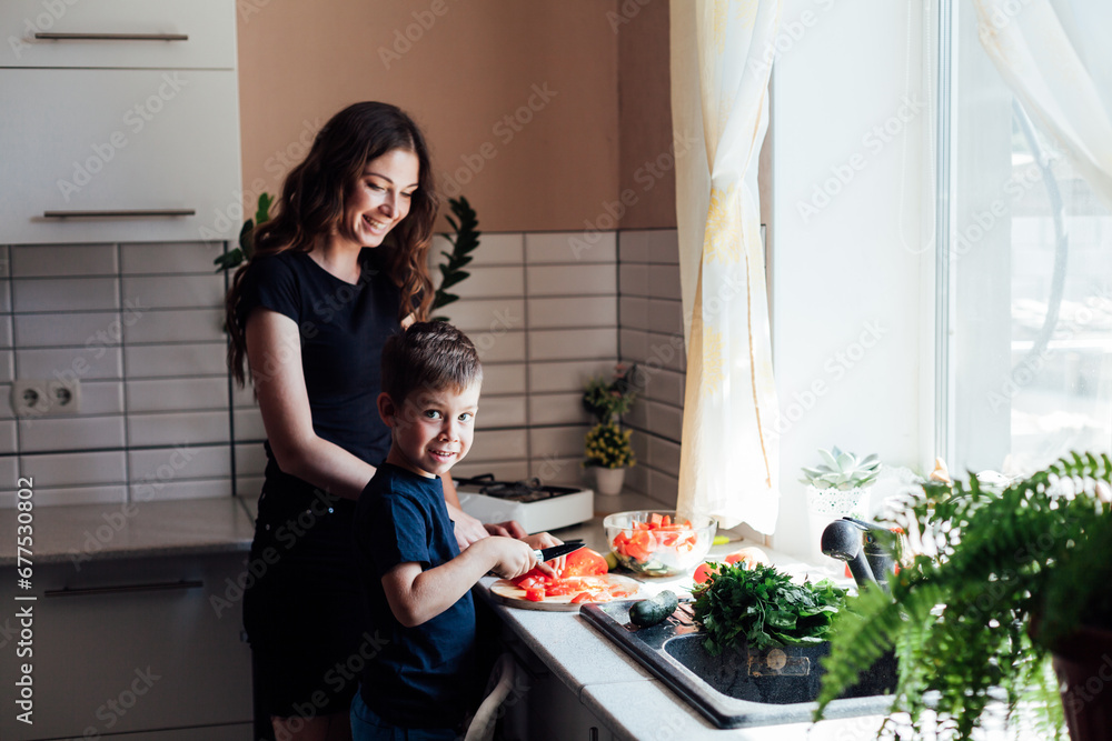 mother and son prepare food in the kitchen healthy food salad vegetables mother and son prepare food in the kitchen healthy food salad vegetables