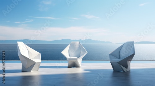 Three white chairs near the sea on a concrete deck.
