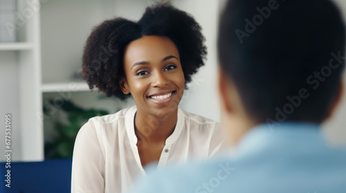psychology, mental health and people concept - smiling psychologist with notebook and woman patient at psychotherapy session