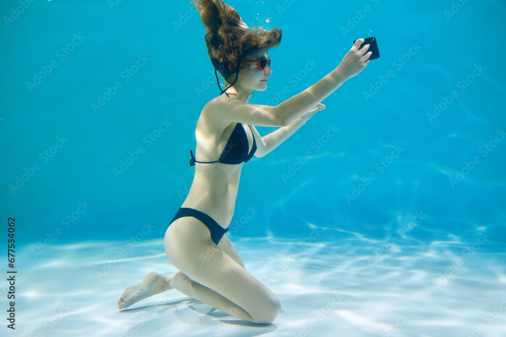 Cute young woman enjoying swimming in a clean pool