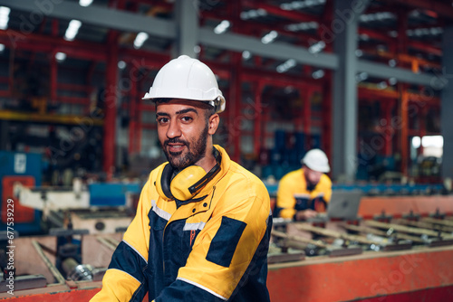 Portrait of Smiling Professional Industry Engineer standing and looking camera, Worker Wearing Safety Uniform and Hard Hat at factory. Machine maintenance technician operation concept.