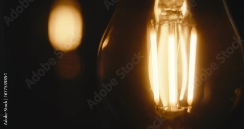 LED light bulbs turn on and off electrical device shine dark close up