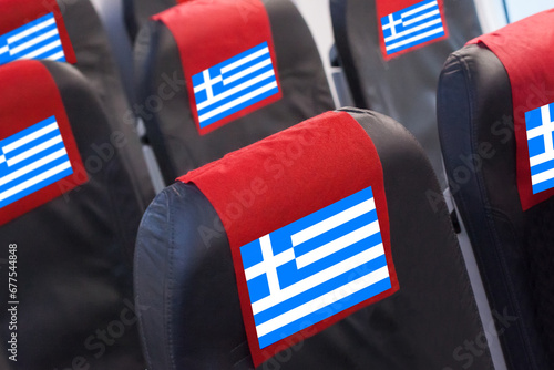 Empty seat in plane with Greek Flag. Travel, flight and transportration in Greece concept