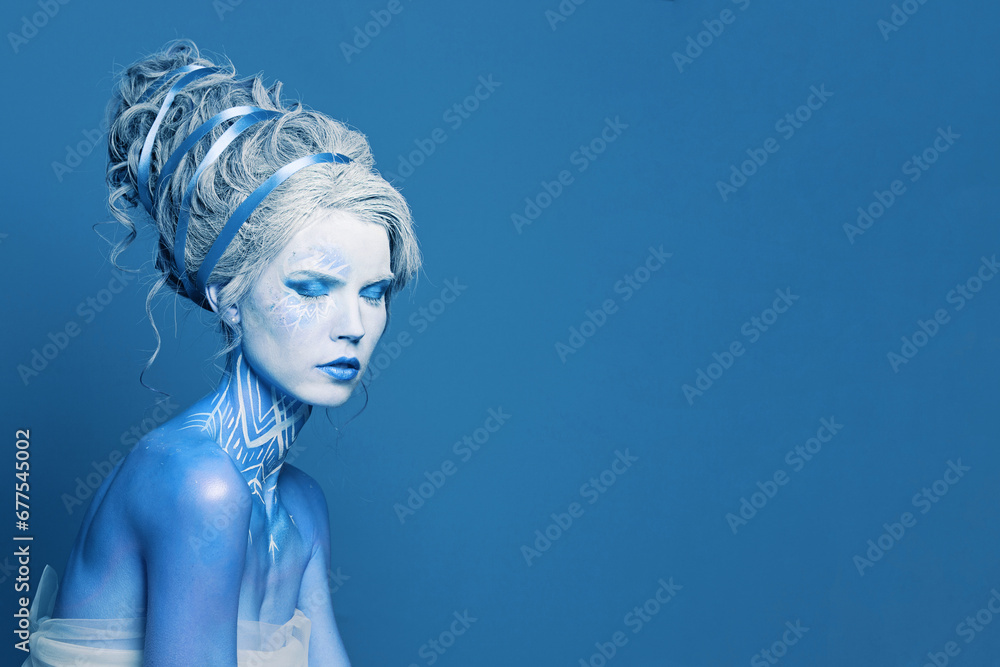 Unusual cool cold woman with blue and white body art, carnival makeup and hairstyle