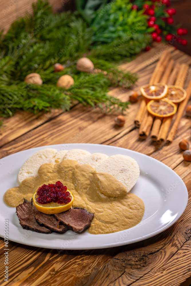 Traditional Christmas dinner in Czech Republic - sirloin in cream sauce
