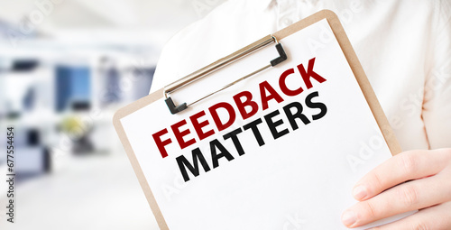 Text FEEDBACK MATTERS on white paper plate in businessman hands in office. Business concept photo