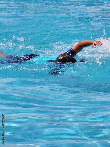 a boy swimming in a swimming pool © fayza
