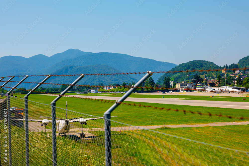 Lugano Airport Runway with Mountain Viewand Clear Sky in a Sunny Day in Ticino, Switzerland.