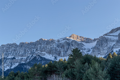 Snow and snowy trees in front of a large snow-capped mountain in northern Spain. Catalonia