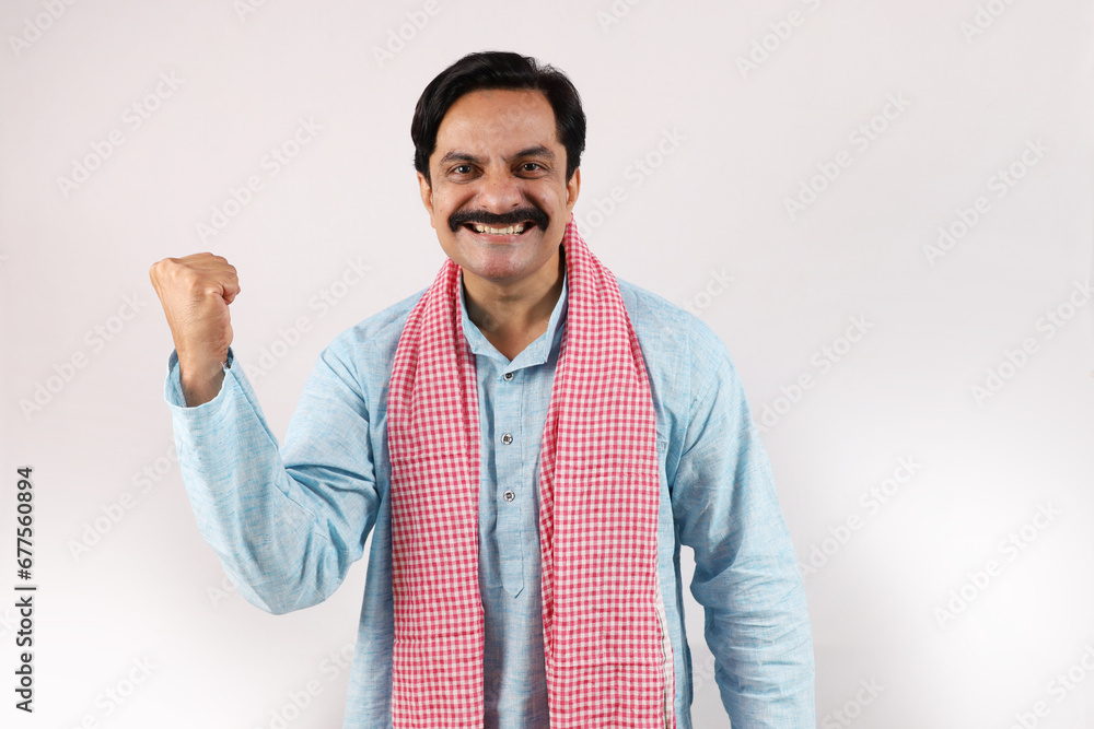 Happy rural Indian farmer standing in the white background, the passionate farmer full of enthusiasm shows sense of achievement and accomplishments. Happy rural Indian farmer standing in the white background, the passionate farmer full of enthusiasm shows sense of achievement and accomplishments.