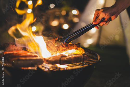barbecue meat grill in family camping party at night