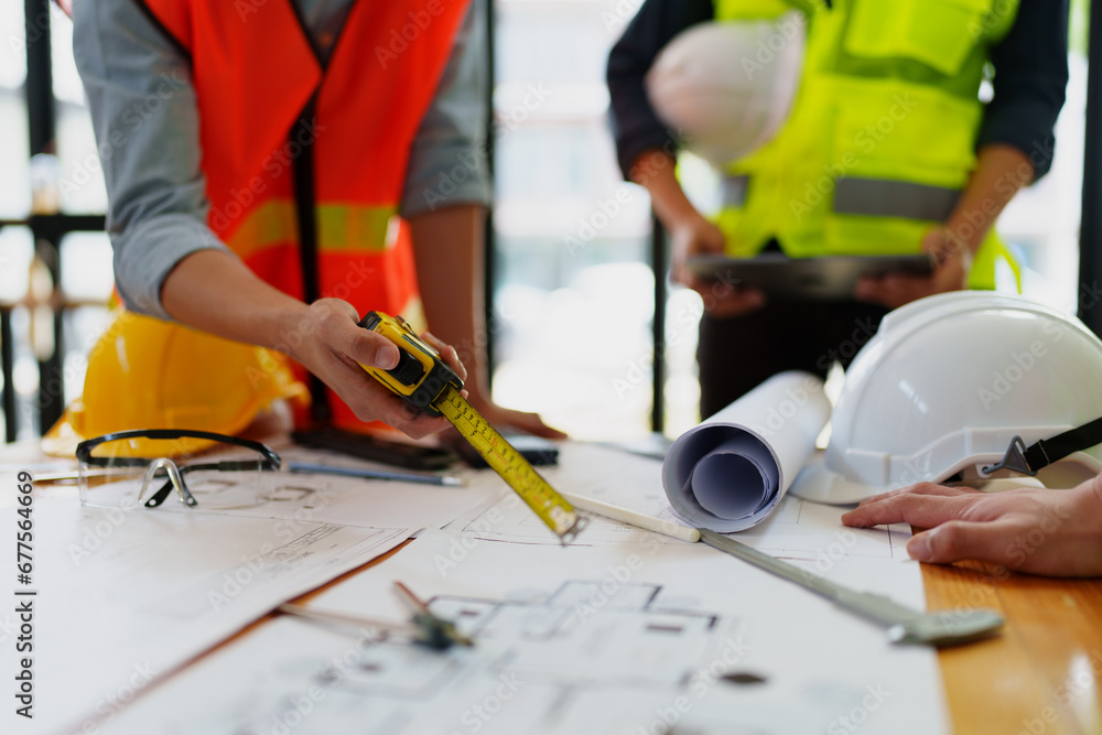 engineers discuss building on blueprint drawing, design building Project in office. engineers discuss building on blueprint drawing, design building Project in office.