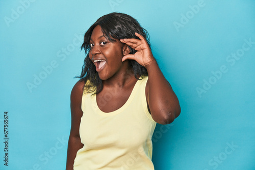 Young african american curvy woman trying to listening a gossip.