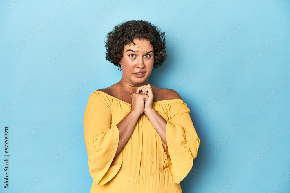 Young Caucasian woman with short hair scared and afraid.