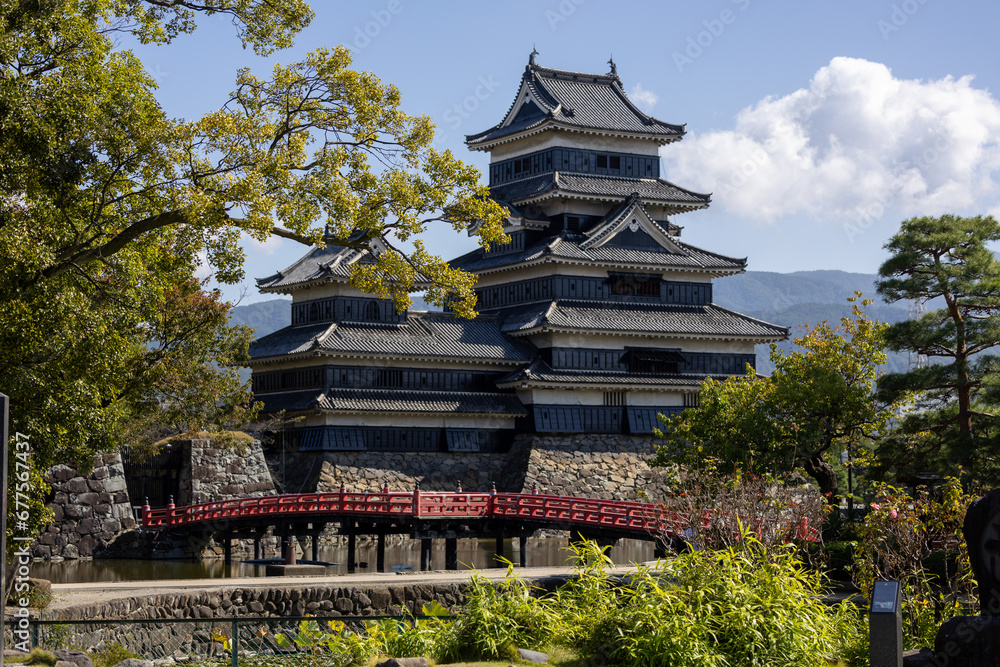 Fototapeta premium Matsumoto castle with red bridge in spring 10 12 2023