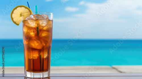 Summer cocktails, sea resort concept. Glass of iced tea. Long island cocktail on tropical beach
