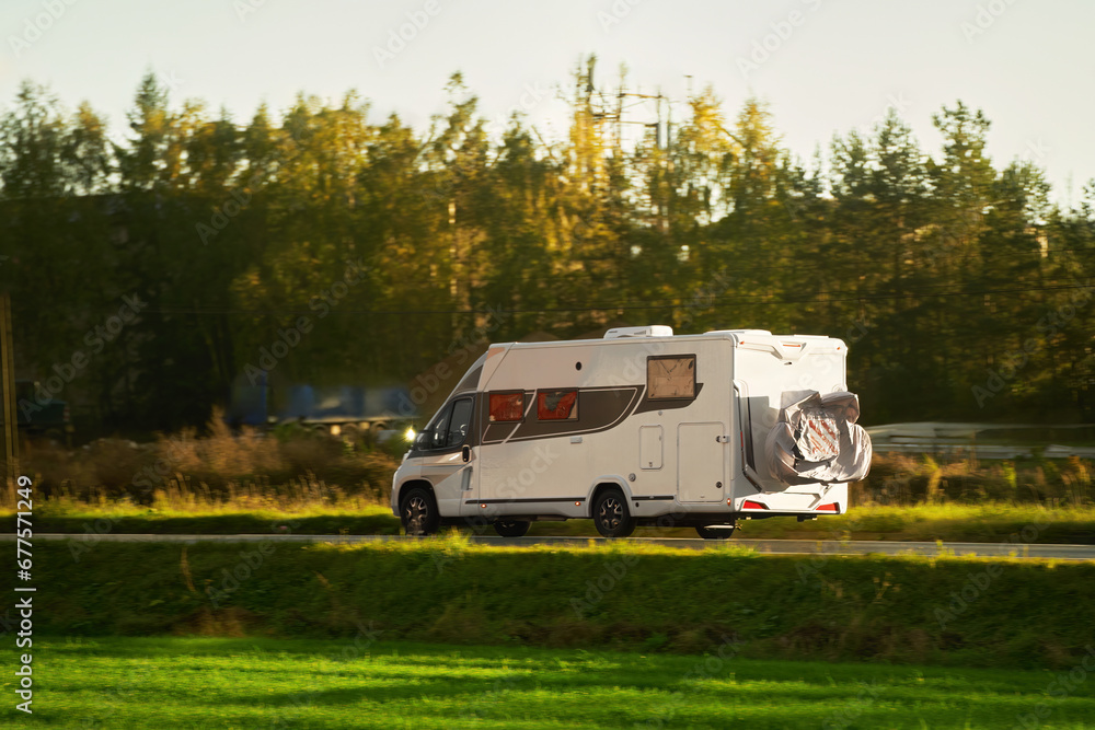 RV motorhome camper van on the highway with bike rack. Travel vacation adventure. Tourists in rental campervan. Tourism in motorhome